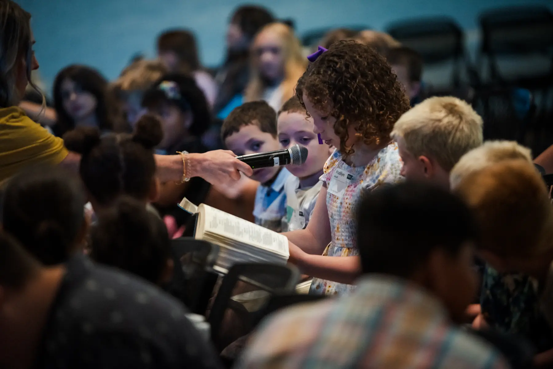 Kids reading along in their Bibles during service