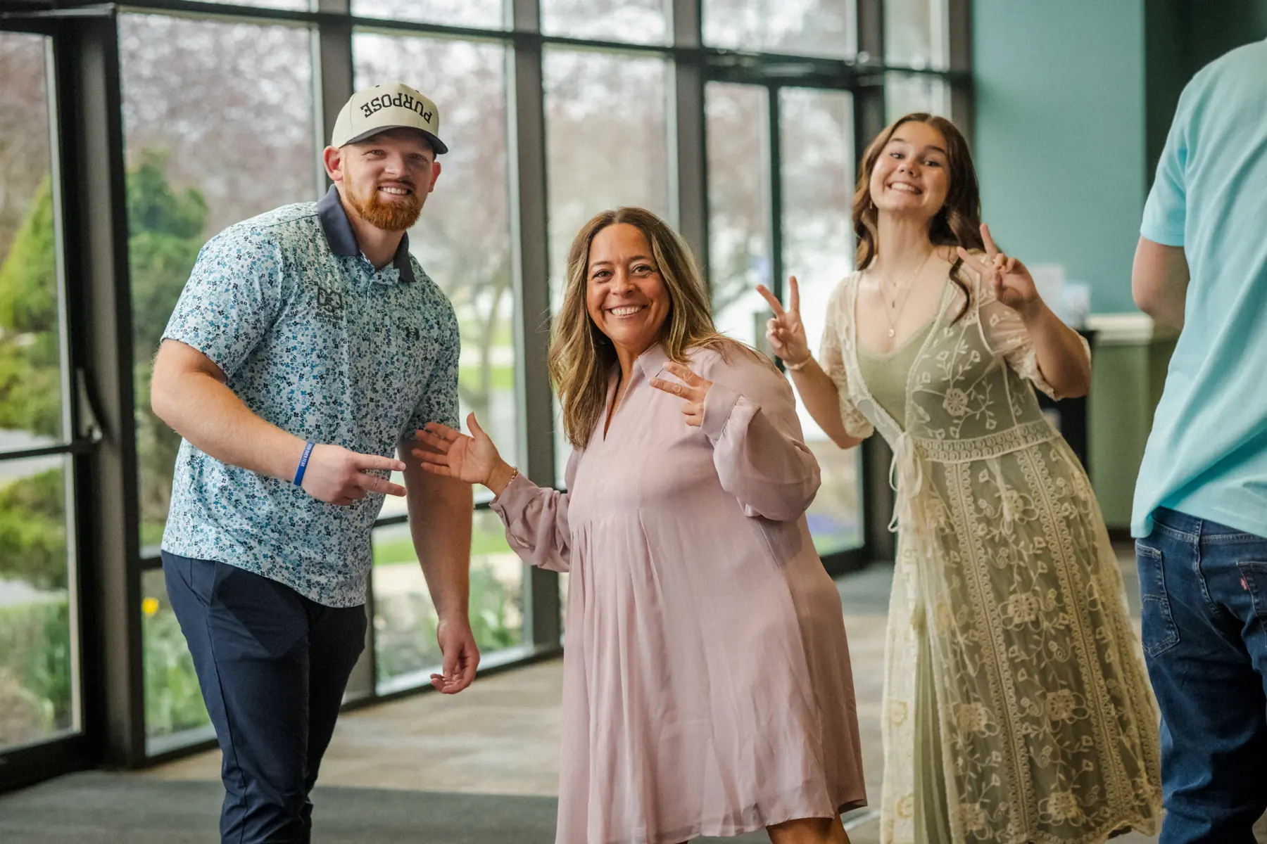 Friends laughing together in the church lobby on Easter Sunday