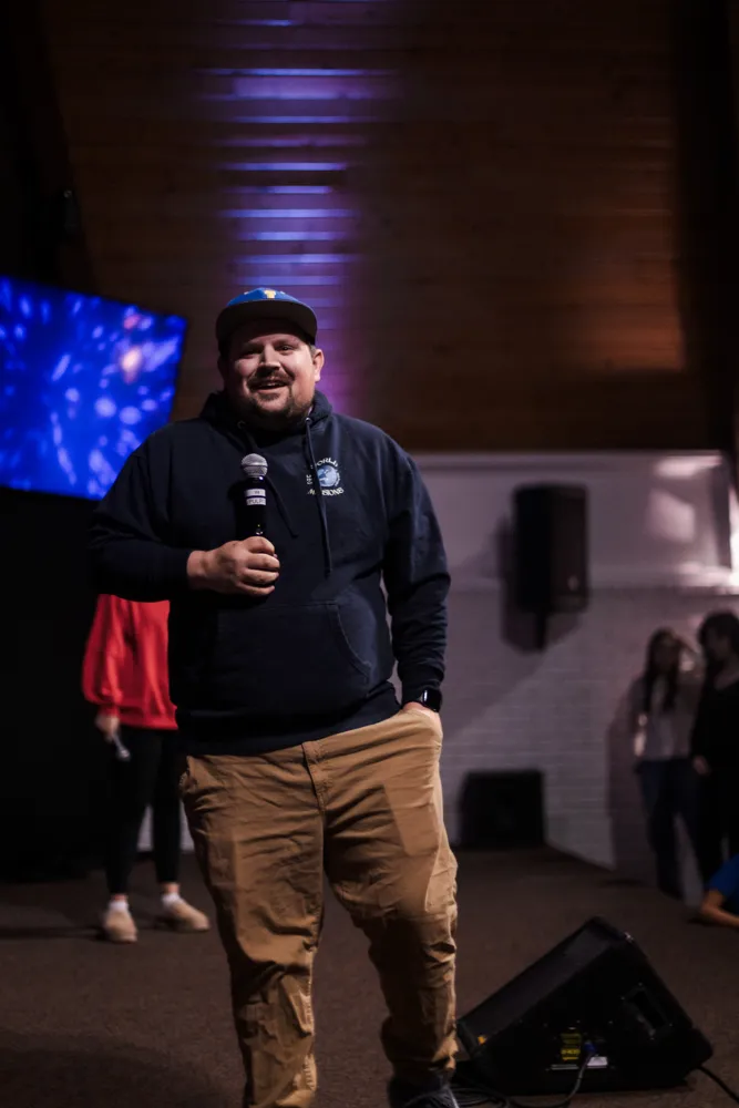 A youth leader speaking from the stage
